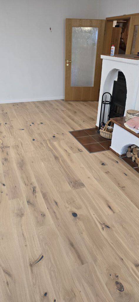 Ansicht des Parkettbodens mit eingefasster Platte am Kamin